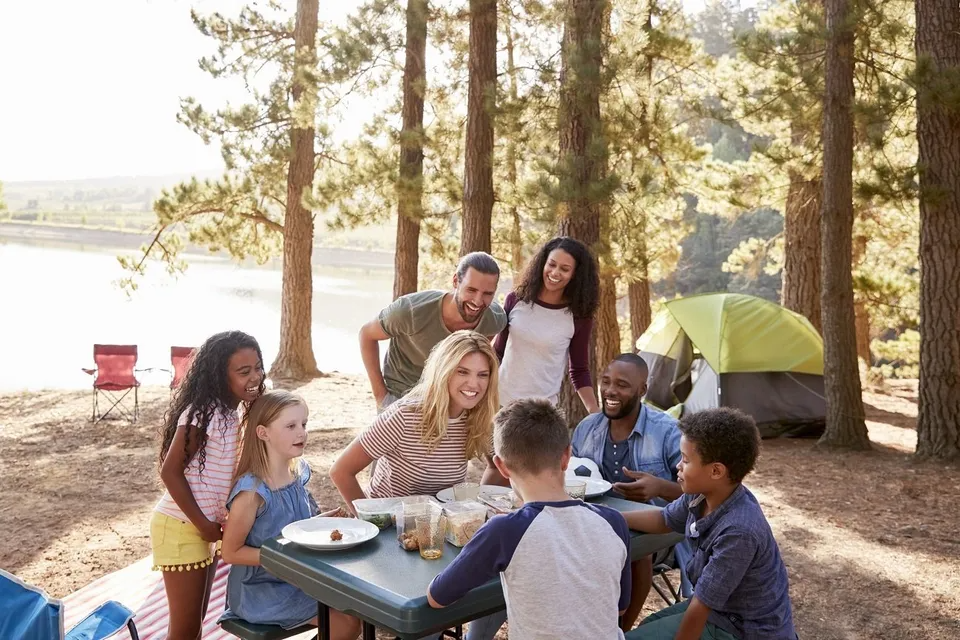 Family and friends camping near lake